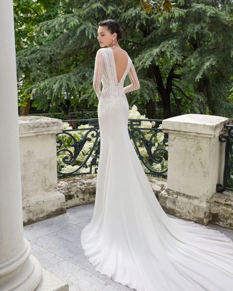 Ballgown-style wedding dress in beaded lace and crepe Georgette. Deep-plunge neckline, V-back and long sleeves. With sheer inserts. Available in natural. 2019 ROSA CLARA COUTURE Collection.