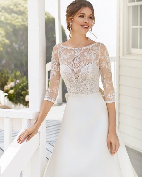 A-line wedding dress and train in sienna and lace. Bateau neckline with long sleeves and V-back. 2020 ROSA CLARA Collection.