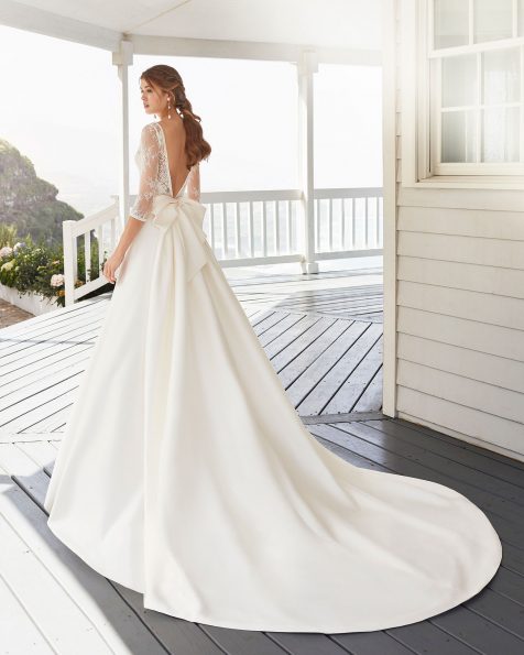 A-line wedding dress and train in sienna and lace. Bateau neckline with long sleeves and V-back. 2020 ROSA CLARA Collection.