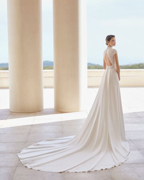 Lightweight wedding dress in guipure lace and crepe. Closed neckline and open back. With short sleeves and pleat at the back of the skirt. 2020 ROSA CLARA COUTURE Collection.