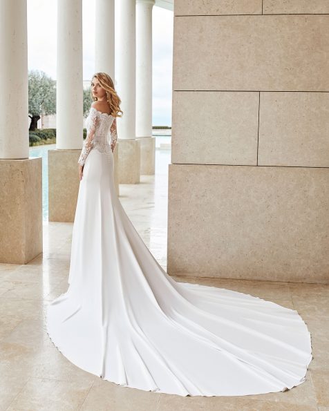 Lightweight wedding dress in lace and crepe. Strapless neckline and long sleeves. With beaded scalloped lace and linear lace detail at the waist. 2020 ROSA CLARA COUTURE Collection.