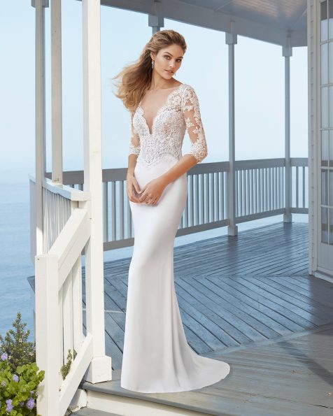 Classic beaded lace wedding dress and overskirt. Illusion-effect deep-plunge neckline with closed lace back. 2020 ROSA CLARA Collection.