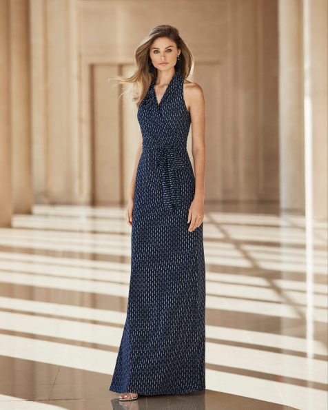 Stretch crepe Georgette cocktail dress. Halter-style V-neckline with a bow at the waist and flower at the shoulder. 2020 ROSA CLARA COCKTAIL Collection.