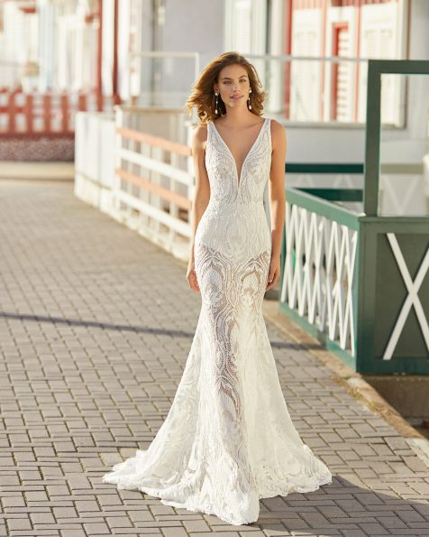 Mermaid-style wedding dress in lace with French knickers and detachable lined underskirt. Deep-plunge V-neckline with linear beading, spaghetti shoulder straps and beaded open back. 2021 ROSA CLARA SOFT Collection.
