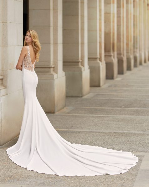 Mermaid-style wedding dress in stretch crepe with button collar and low back with beading. 2021 ROSA CLARA Collection.