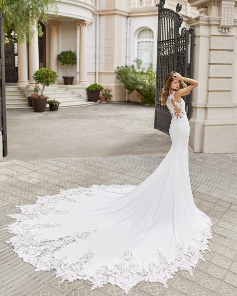 Mermaid wedding dress in stretch crepe with oval neckline and sheer back with appliqués and sequins. With appliqués on train. 2021 ROSA CLARA Collection.